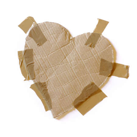 Rough heart-shaped cardboard with wrapping tape isolated in whiteの写真素材