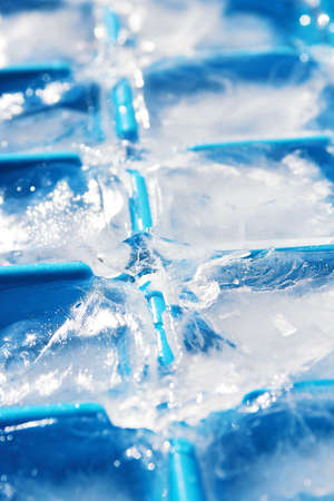 Closeup of ice cubes in a blue ice cube container