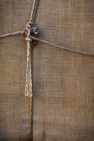 background of sackcloth wrap tied up with ropesの写真素材