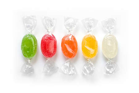 assorted colorful candies in plastic wraps isolated in white backgroundの写真素材