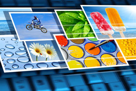 Fast flow of digital photos over the keyboard of a laptopの写真素材