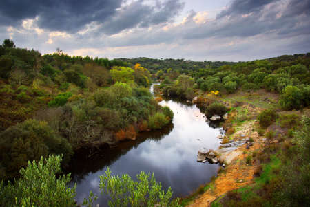 Landscape of a calm river and cloudy sky in Alentejo, Portugal の写真素材