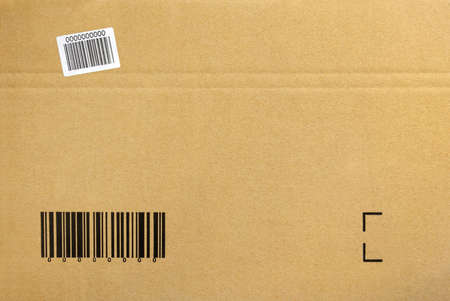 Cardboard background of a closed package box with printed barcodeの写真素材