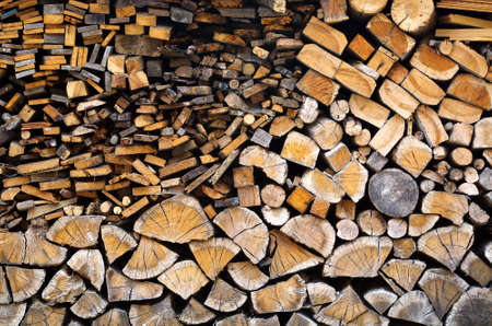 Detail of piled firewood trunks and planksの写真素材
