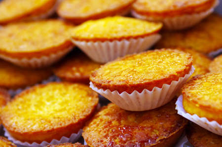 Closeup on many little delicious pastry cakes displayed in a table