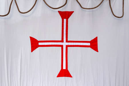 Detail of a model of the historic portuguese Cross of Christ in the white sail of a acient ship の写真素材