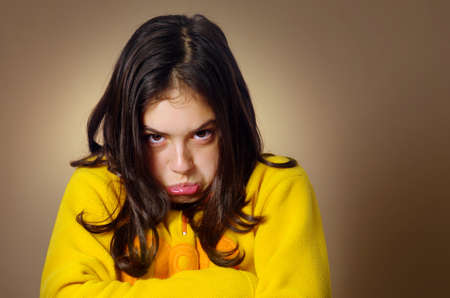 Spoiled young girl with pouty expression and being very stubborn