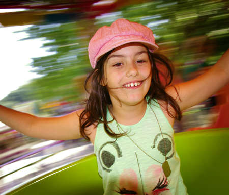Little girl having fun in a carousel の写真素材
