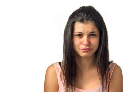 Brunette teenager girl crying with sadness expression の写真素材
