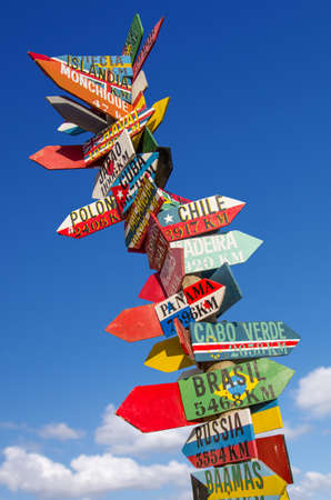 Many colorful wooden direction signs to far locatiosのeditorial素材