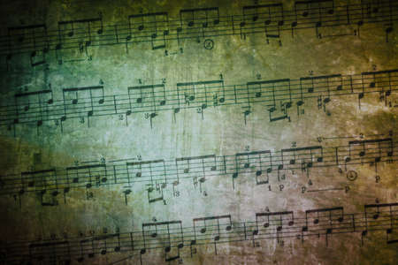 background of weathered and textured old music sheetの写真素材