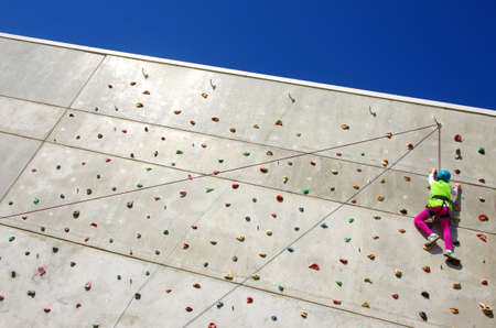 Youngster's effort in climbing a wall to reach the topの写真素材