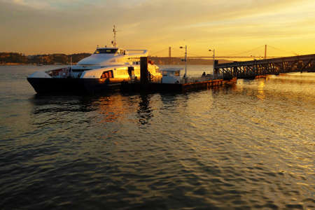 Ferryboat docked ina pier in Lisbon at Sunsetの写真素材