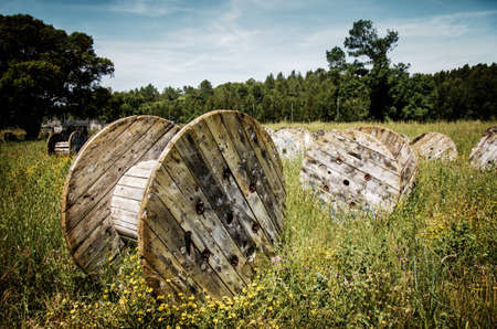 Abandoned electric cable reels in a paintball battle fieldの写真素材
