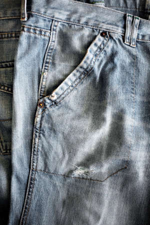 Closeup detail of a washed out blue jeans pocketの写真素材