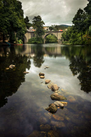 Landscape of a river and ancient Roman bridge in Portugalの写真素材