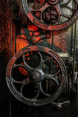 Closeup on old industrial wheels and steel cable