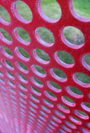 Perforated red panel with little round holesの写真素材