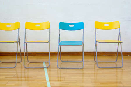 Photo of row of colorful chairs in a indoor sports facilityの写真素材
