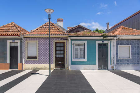 Typical small houses decorated with traditional tiles in the city of Aveiro, Portugal.の写真素材