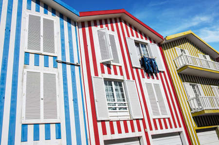 Typical small wooden houses with colorful stripes in Costa Nova neighborhood, Aveiro, Portugal.の写真素材