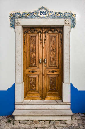 Typical recovered door in a building in the village of Ericeira, Portugalのeditorial素材