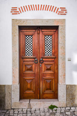 Typical recovered door in a building in the village of Ericeira, Portugalのeditorial素材