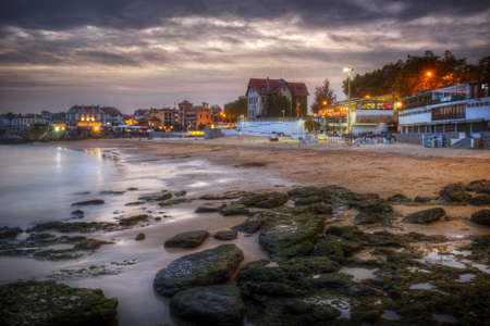 View of empty Cascais beach in Portugal in a cloudy winter eveningの写真素材