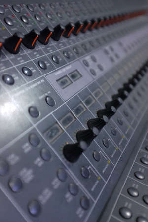 Sound mastering table with many buttons, sliders and ledsの写真素材