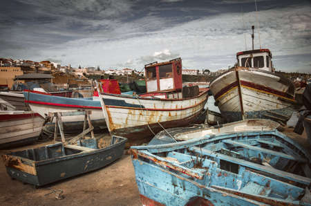 Old fishing boats docked in a port in Sines - Portugalの写真素材