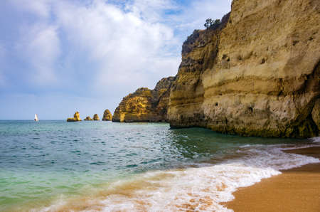 View of the ocean and cliffs in Dona Ana Beach in Lagos, Portugalの写真素材