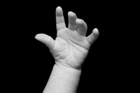 Baby s Hand Isolated on a Black Backgroundの写真素材
