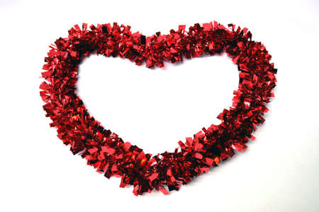 red garland in heart shape isolated on white background close upの写真素材