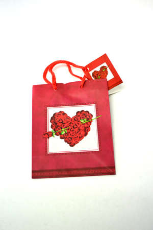 flat red heart gift bag isolated on white backgroundの写真素材