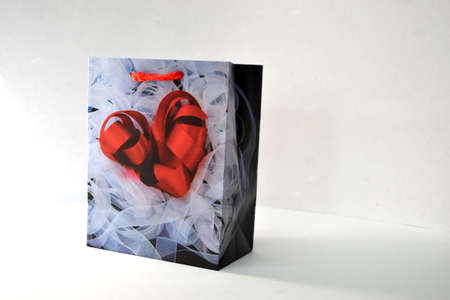 red heart gift bag isolated on white background close upの写真素材