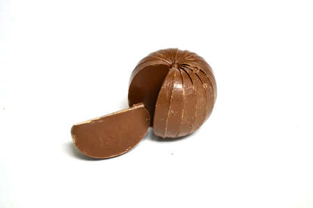 slice of chocolate from a chocolate sphere isolated on white backgroundの写真素材