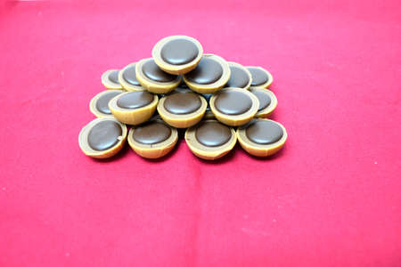 chocolates forming a pyramid isolated on red backgroundの写真素材