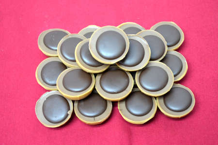 chocolates forming a pyramid isolated on red background close upの写真素材