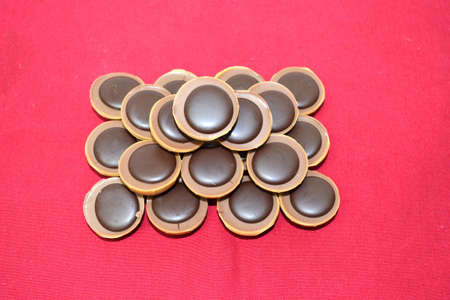 pyramid of chocolates isolated on red background close upの写真素材