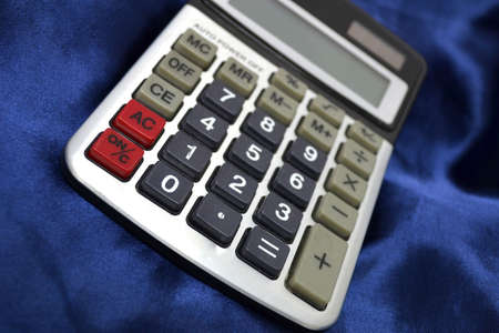 calculator on smooth blue satin close upの写真素材