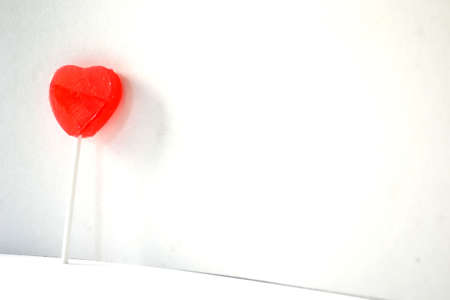 red heart lollipop isolated on white backgroundの写真素材
