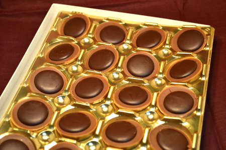 box of chocolates isolated on burgundy close upの写真素材