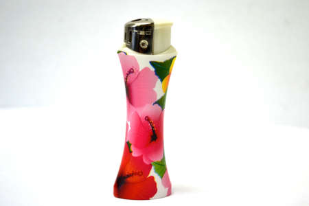 flower decorated lighter isolated on white background close upの写真素材