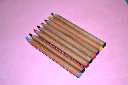 wooden pencil crayons isolated on pink background close upの写真素材