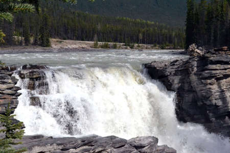 Waterfall located along the Athabasca River in Jasper National Park in Alberta, Canadaの写真素材