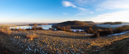 Autumn panorama with lake and hillsの写真素材