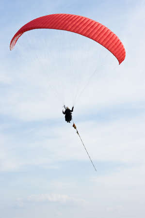 Red paraglider on the ropeの写真素材