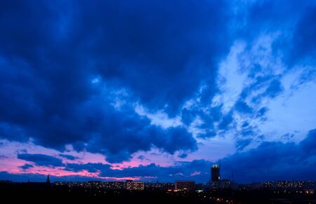 Dramatic sunset in blue tone over the cityの写真素材