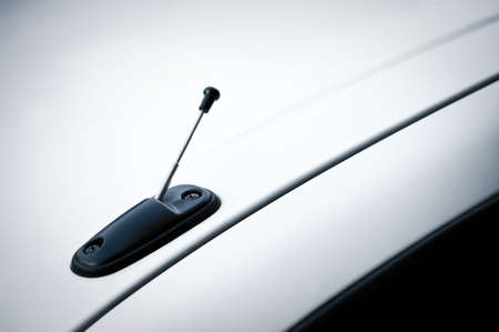 Telescopic antenna on the roof of white carの写真素材