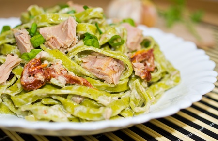 Green tagliatelle with tuna and dried tomatoesの写真素材